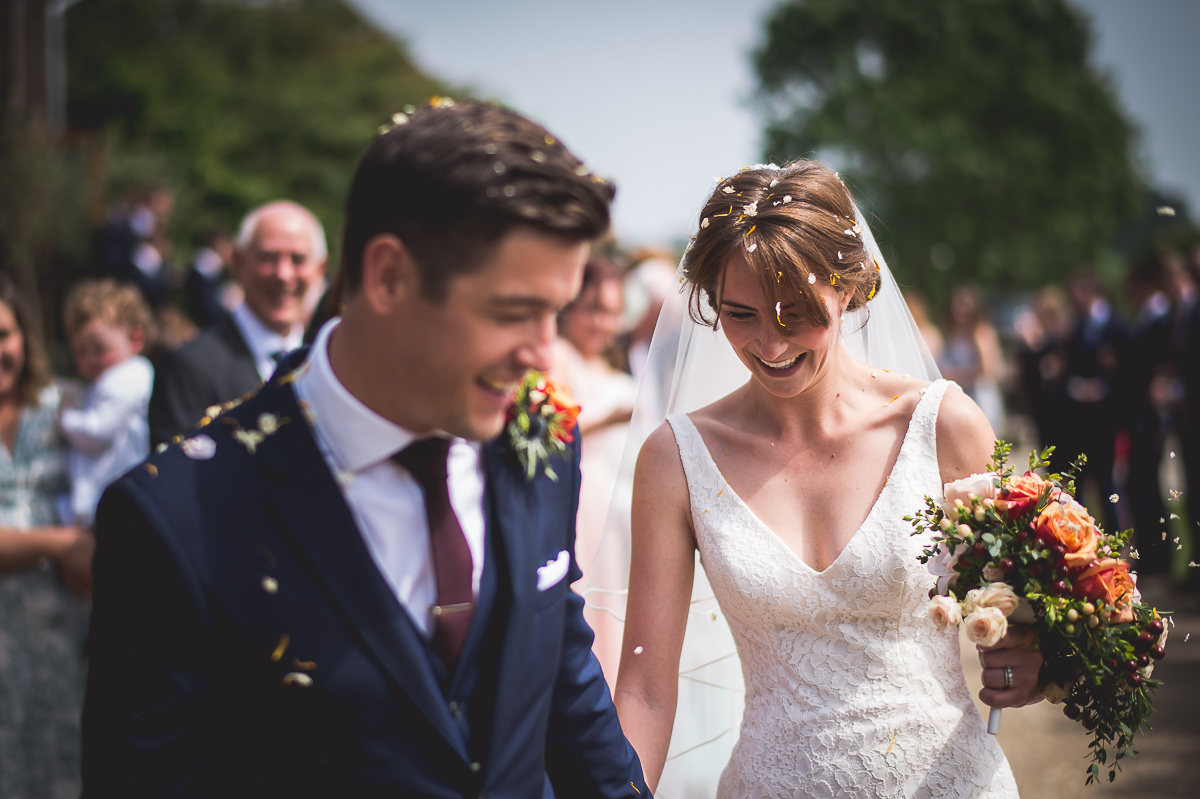 A wedding couple elegantly progresses down the aisle, captured by a skilled wedding photographer for timeless wedding photos.