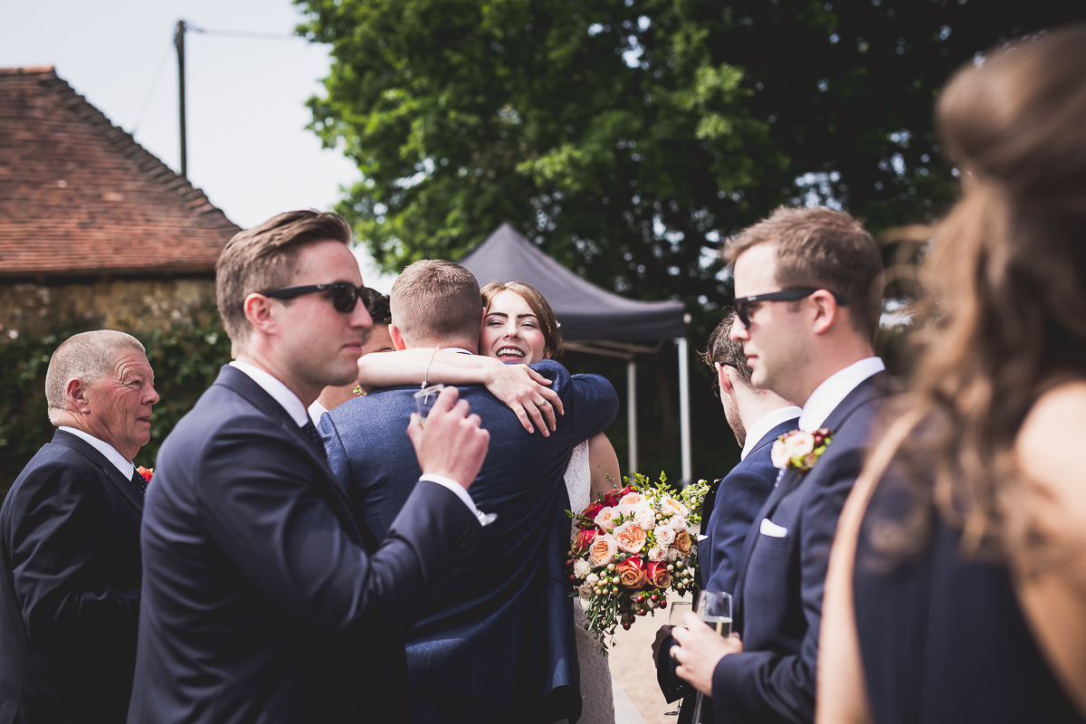 A groom embracing his bride captured by a wedding photographer.