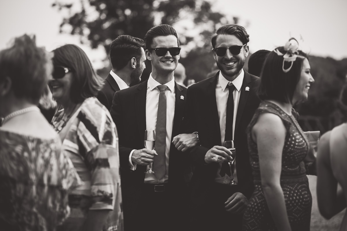 A black and white photo of a group of men at the wedding, including the groom.