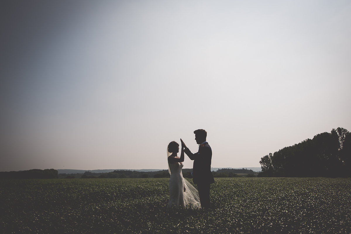 A silhouette of a bride and groom in their wedding photos.