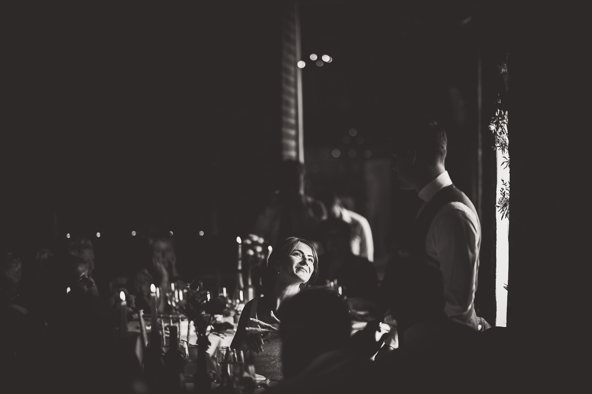Black and white wedding photo of a bride and groom at a table.