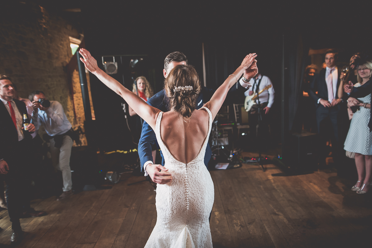 A bride and groom dancing at their wedding reception, captured by a wedding photographer.