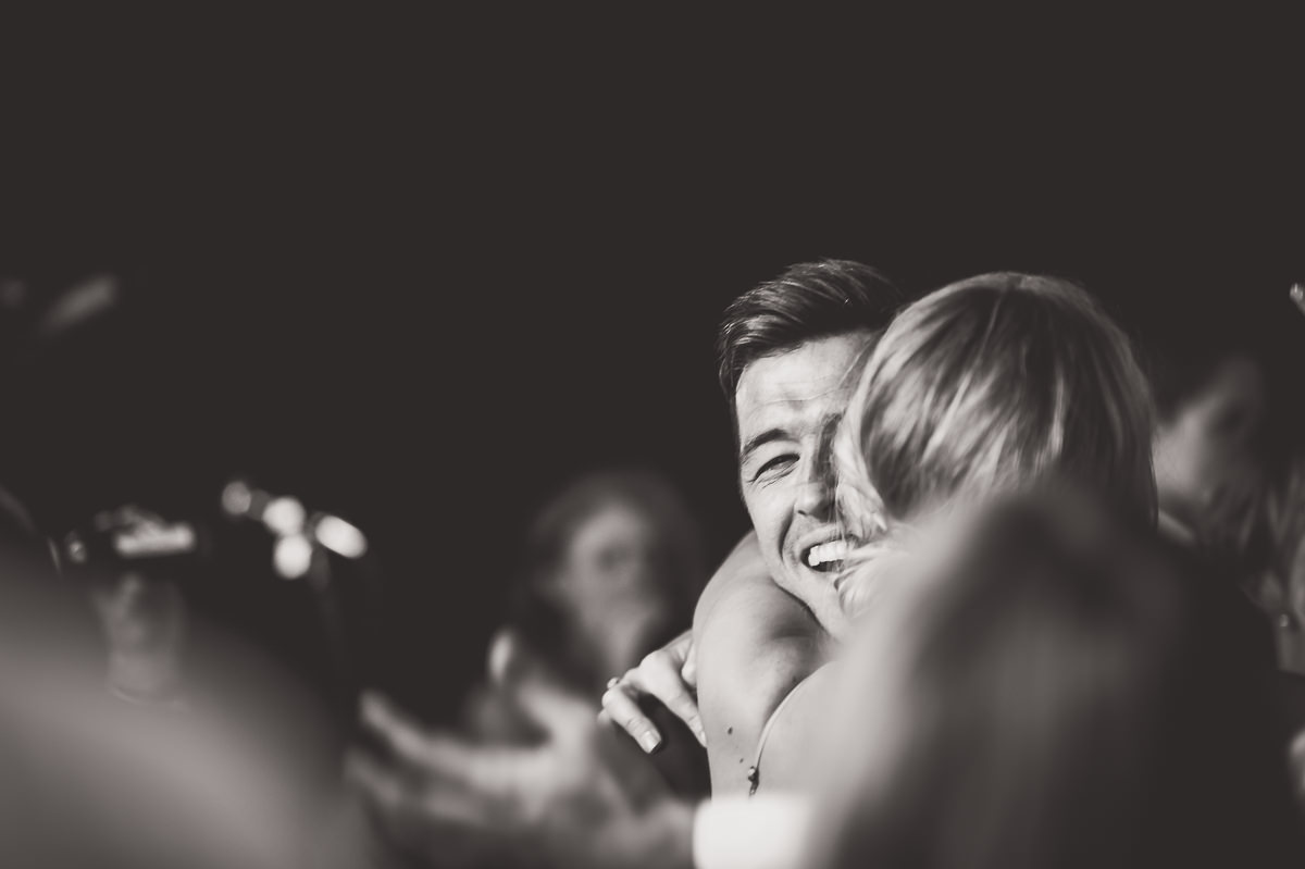 A bride and groom embracing in a wedding photo.