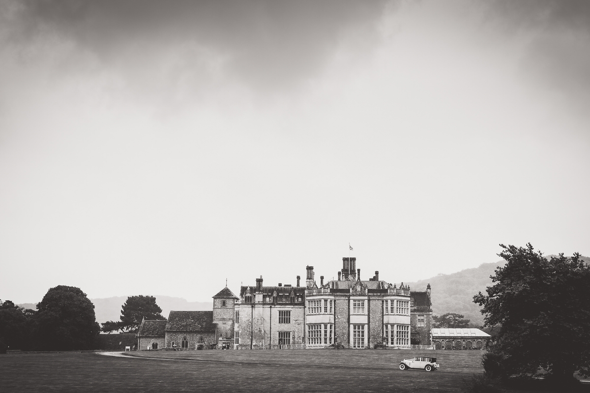 A black and white photo of a large mansion captured by a wedding photographer.