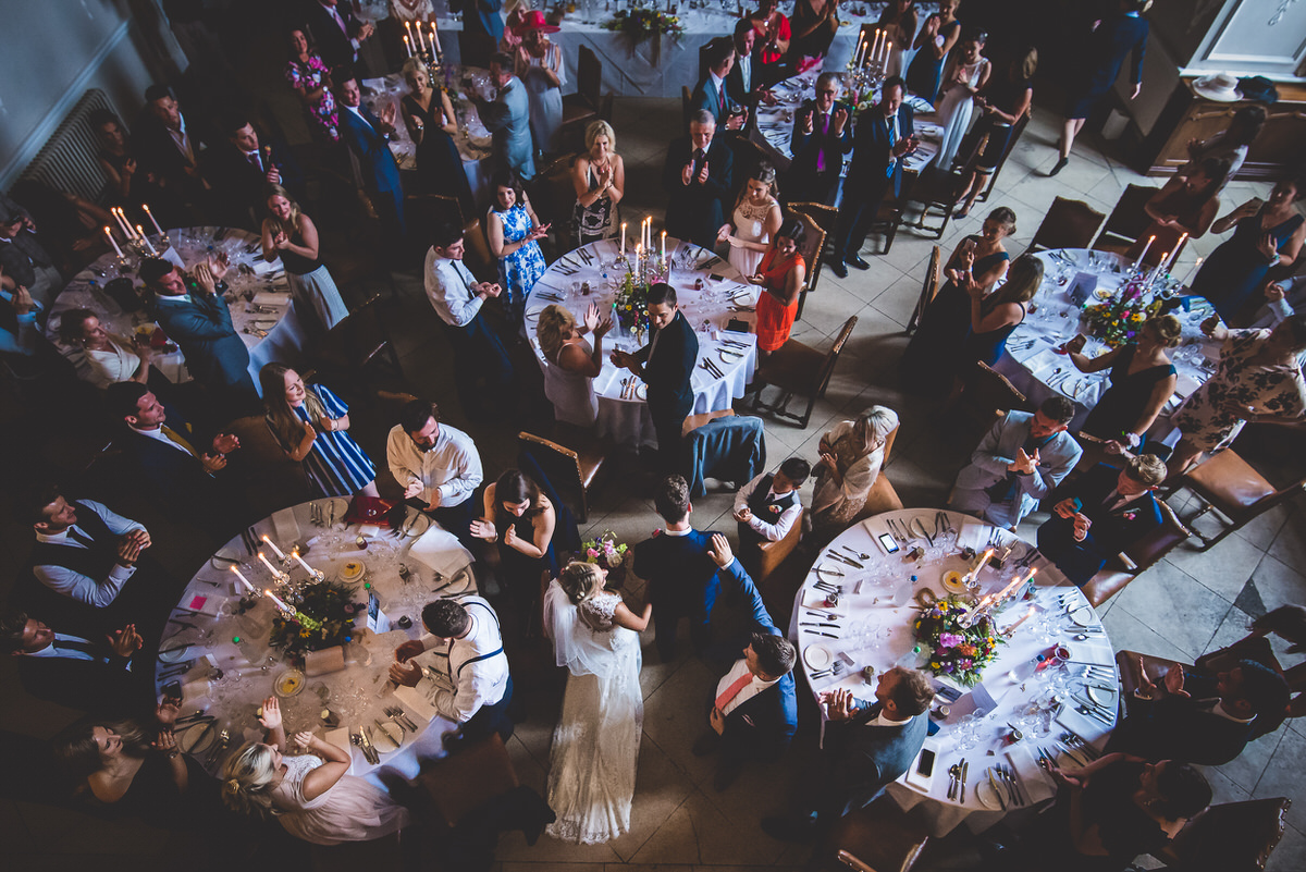 An overhead view of a wedding reception capturing the bride and wedding decor.