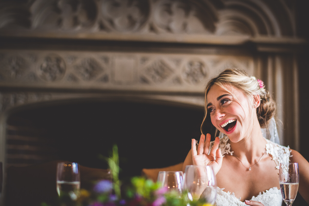 A bride's laughter captured by the wedding photographer in a heartwarming wedding photo.