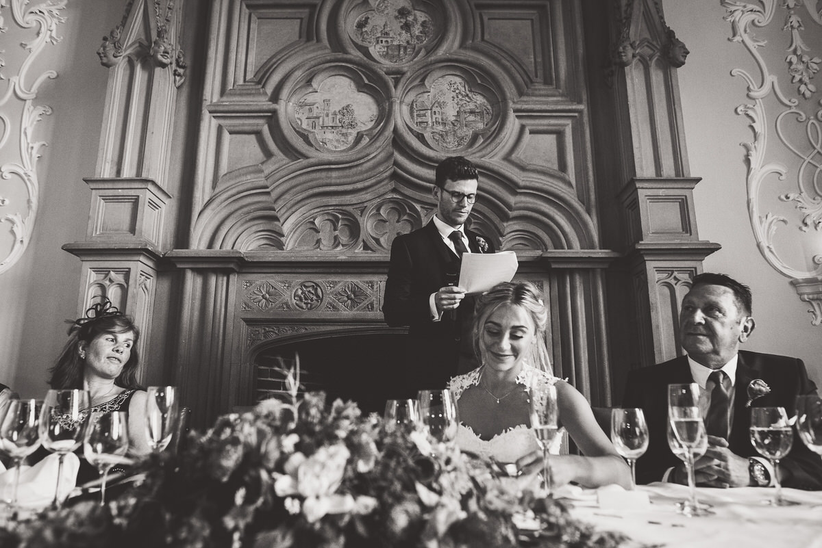 A wedding photographer captured a black and white photo of the bride and groom.