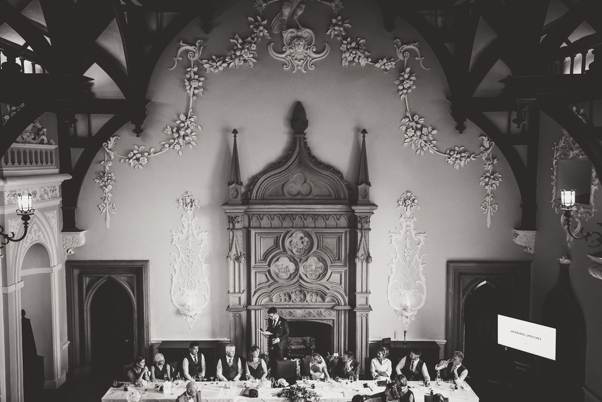 A black and white photo capturing the wedding reception of a bride and groom.