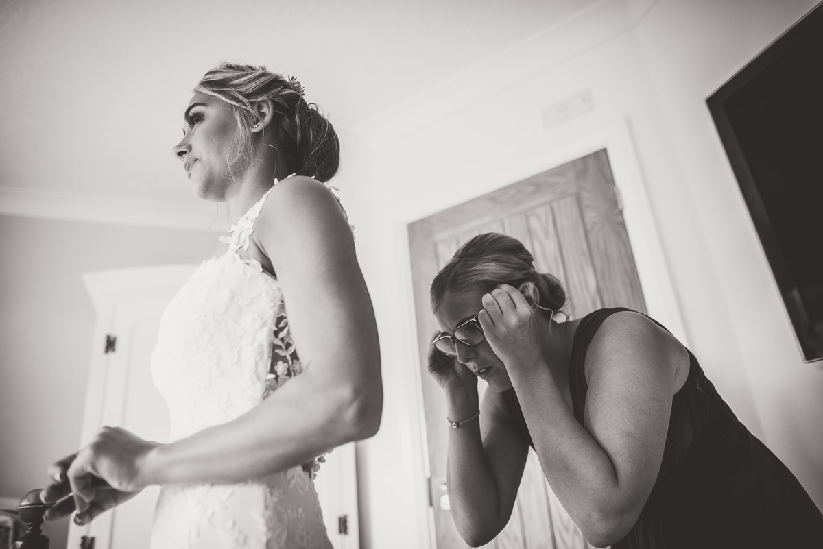 A bride preparing for her wedding captures the moment with a wedding photographer.