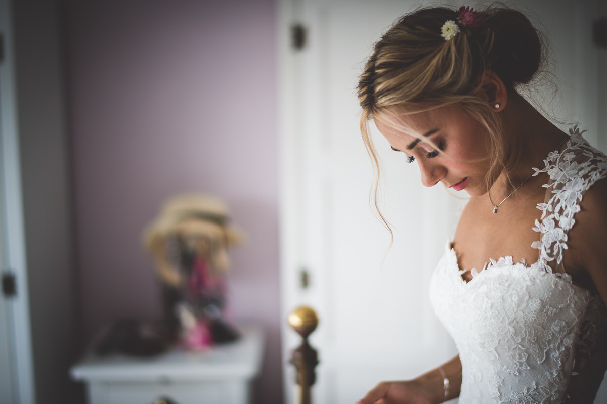 A bride is getting ready for her wedding day, as captured by a wedding photographer.