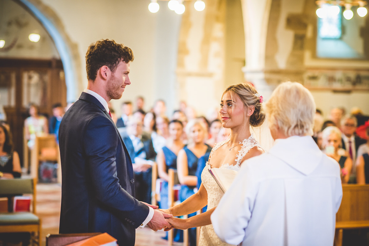 The bride and groom celebrate their wedding by exchanging vows in a church.