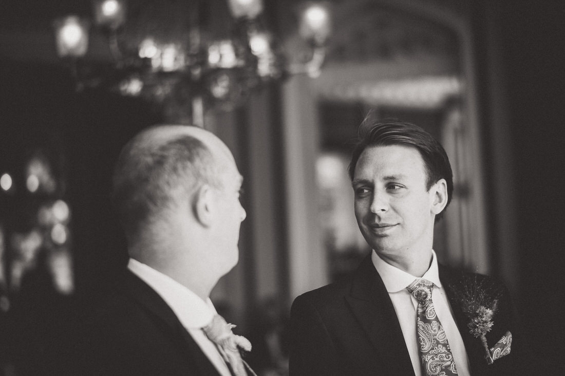 Black and white wedding photo of groom and groomsmen.