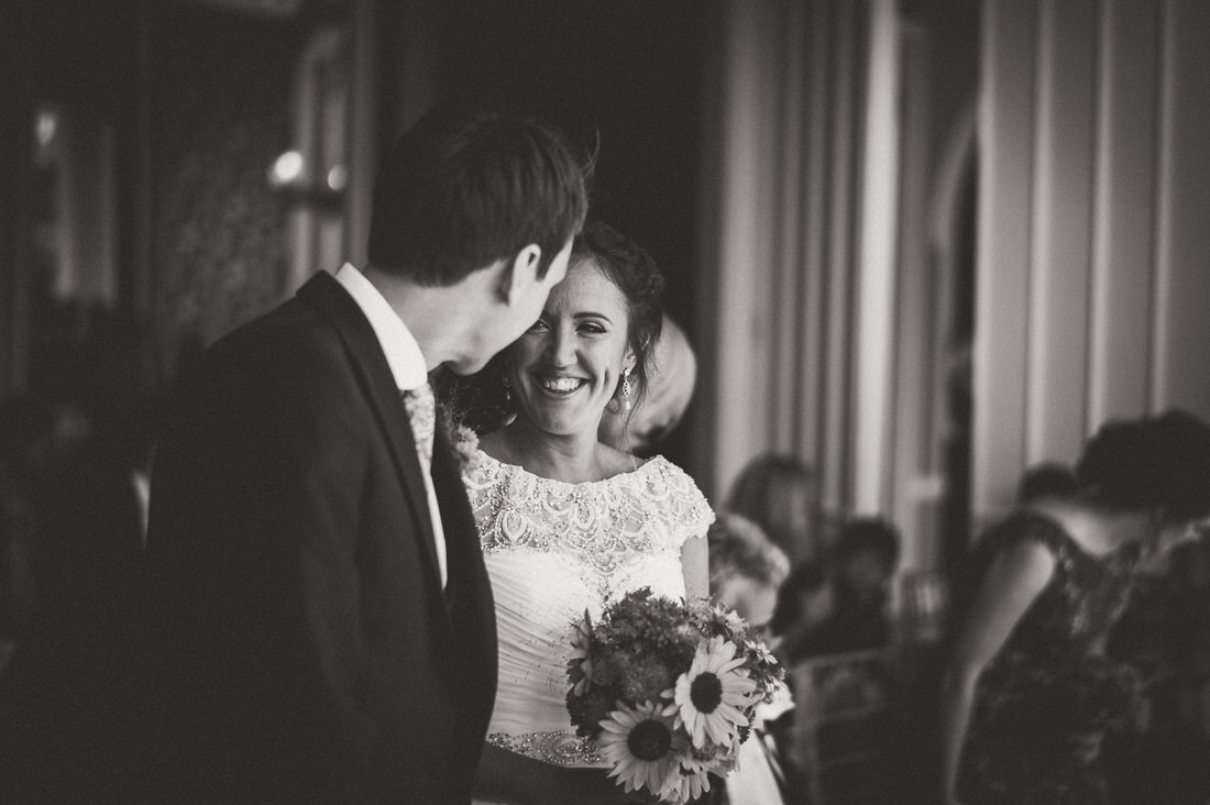 A wedding photo capturing the smiling bride and groom during their ceremony.