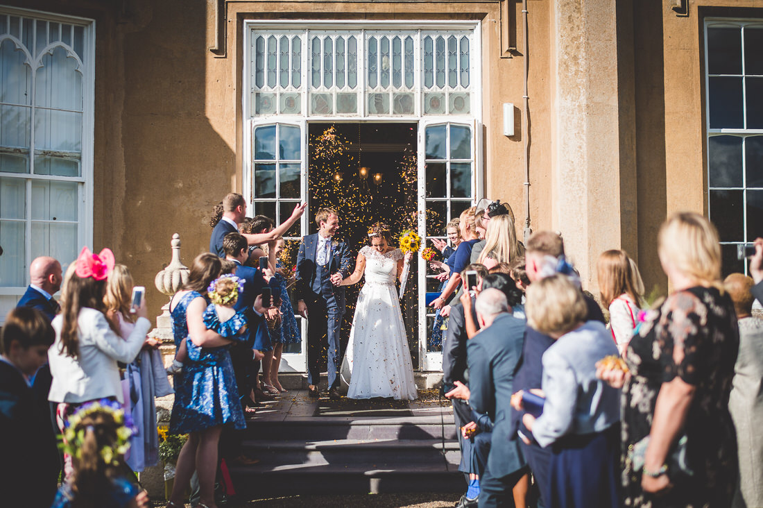 A wedding ceremony featuring groom and bride at a manor house.