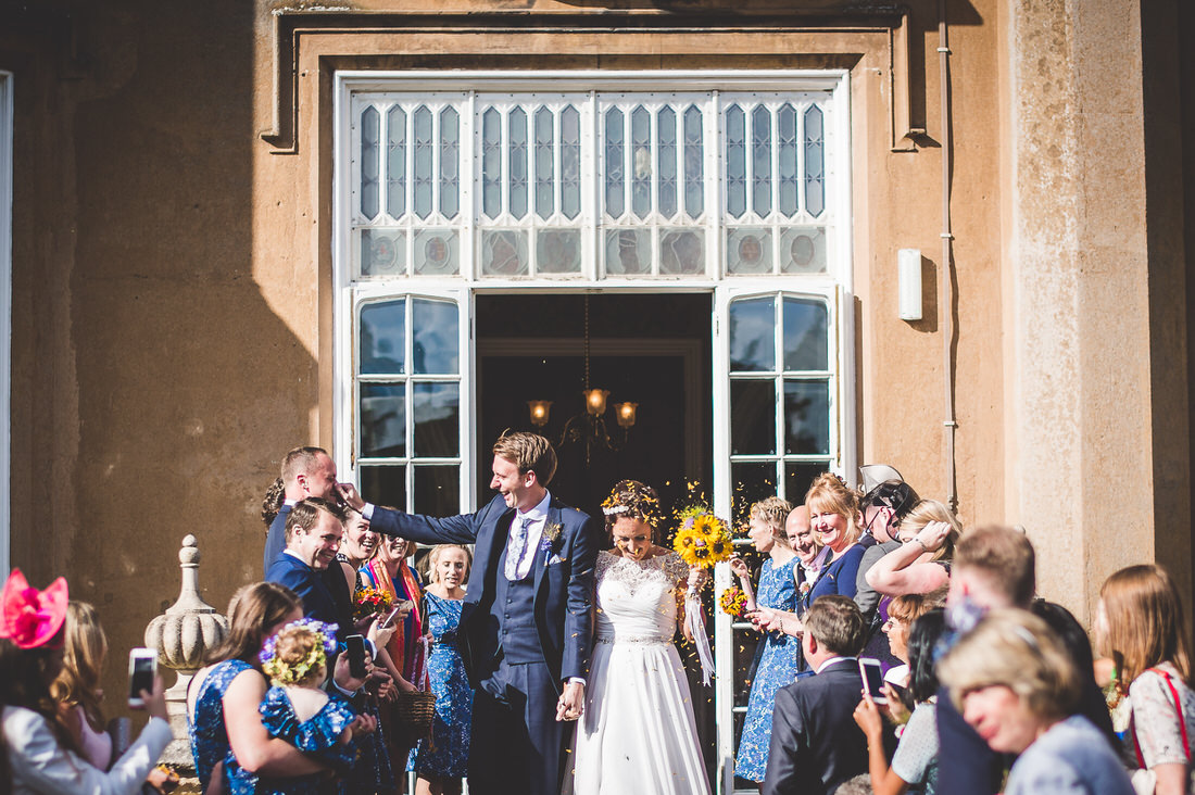 A wedding couple posing outside the venue for a beautiful wedding photo.