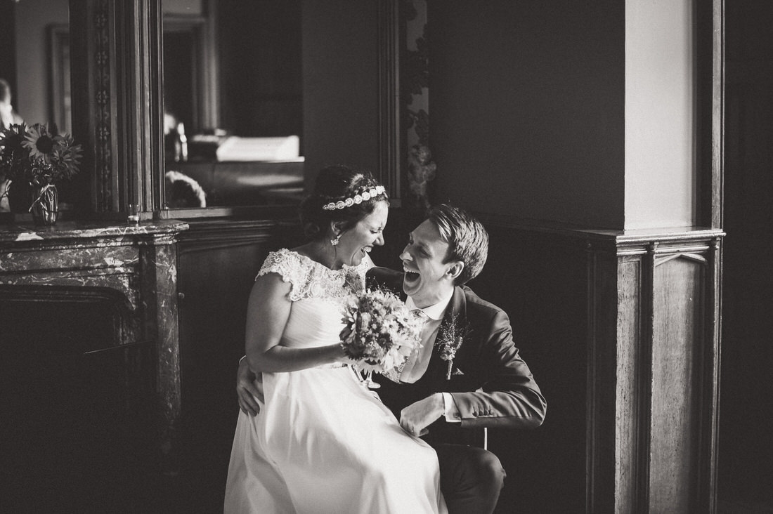 A wedding photo of a bride and groom in front of a mirror.