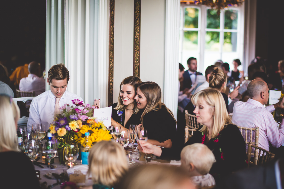 A group of people sitting at a wedding reception.