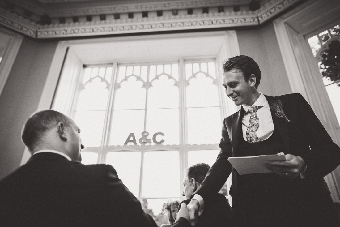 A man is shaking hands with another man at a wedding.
Keywords: wedding photo, bride