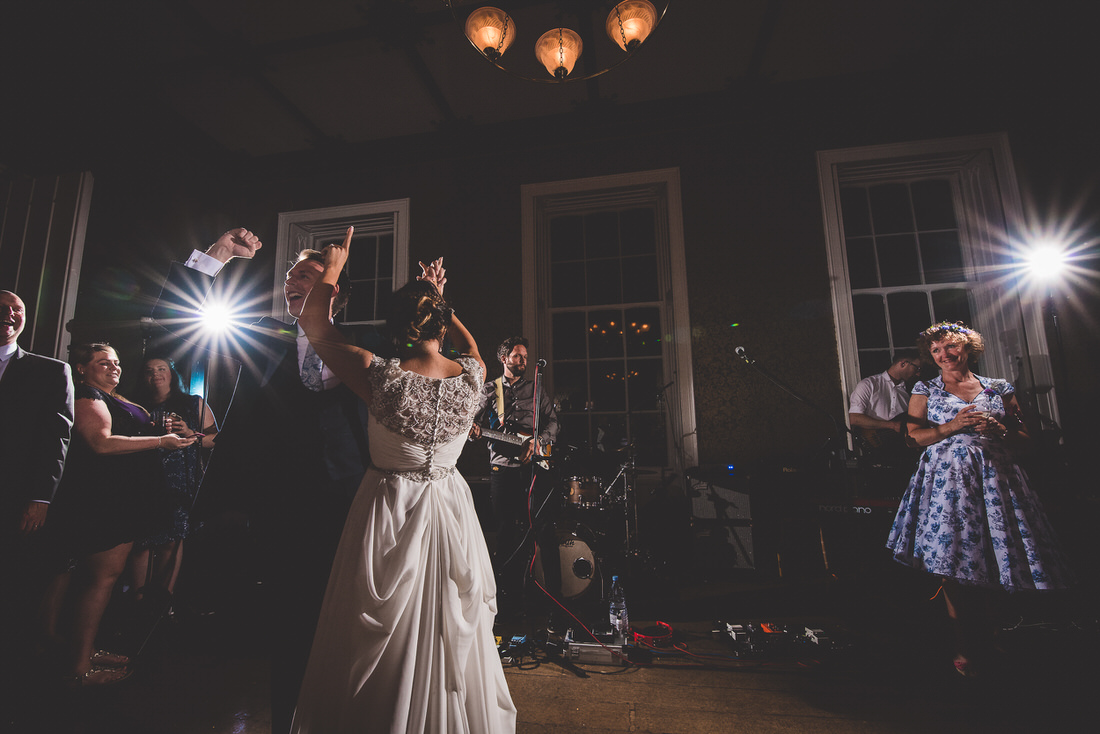 A bride and groom gracefully dancing at their wedding reception, beautifully captured by a talented wedding photographer.
