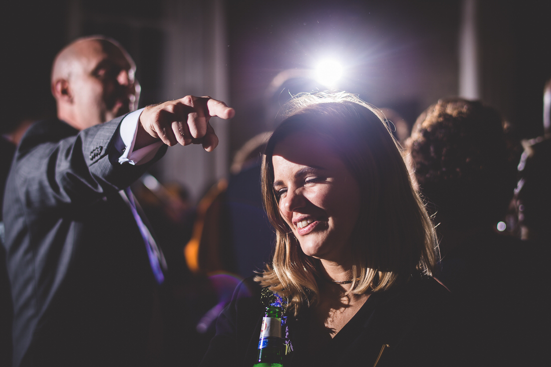 A bride pointing at the groom in a wedding photo.