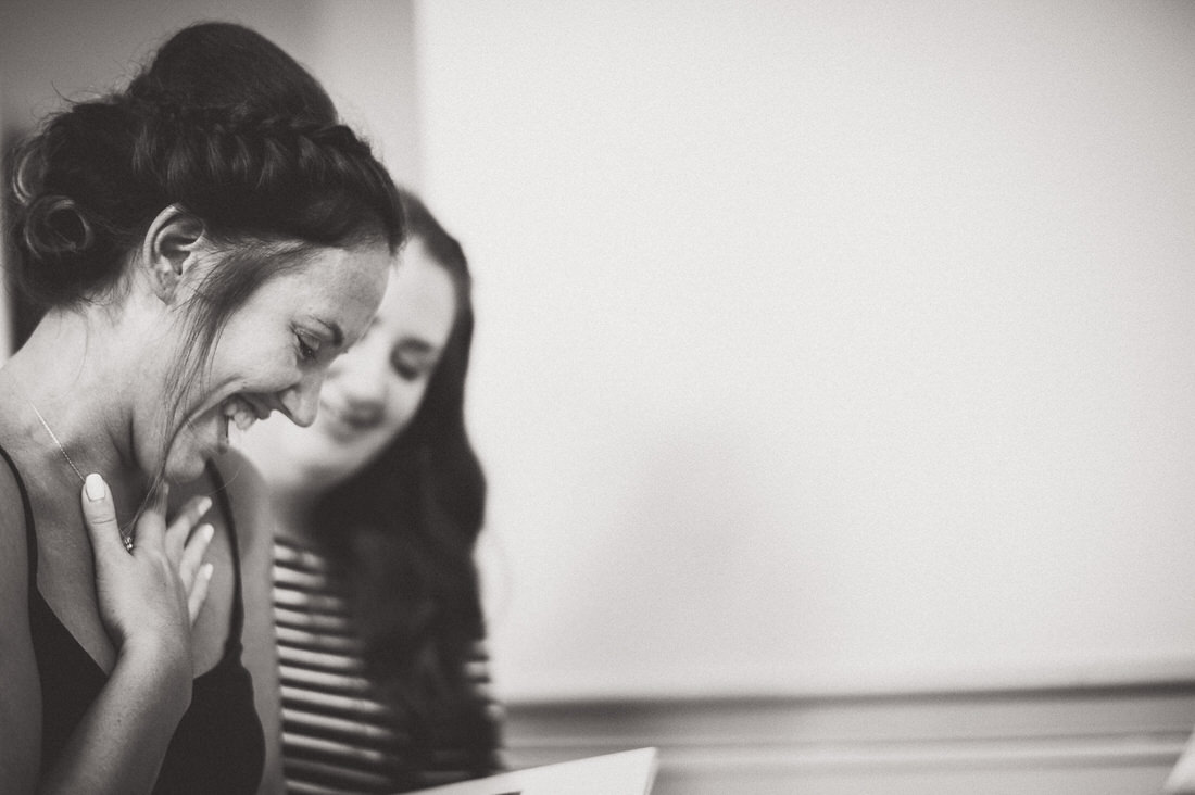 A joyful woman enjoys a book on her wedding day.