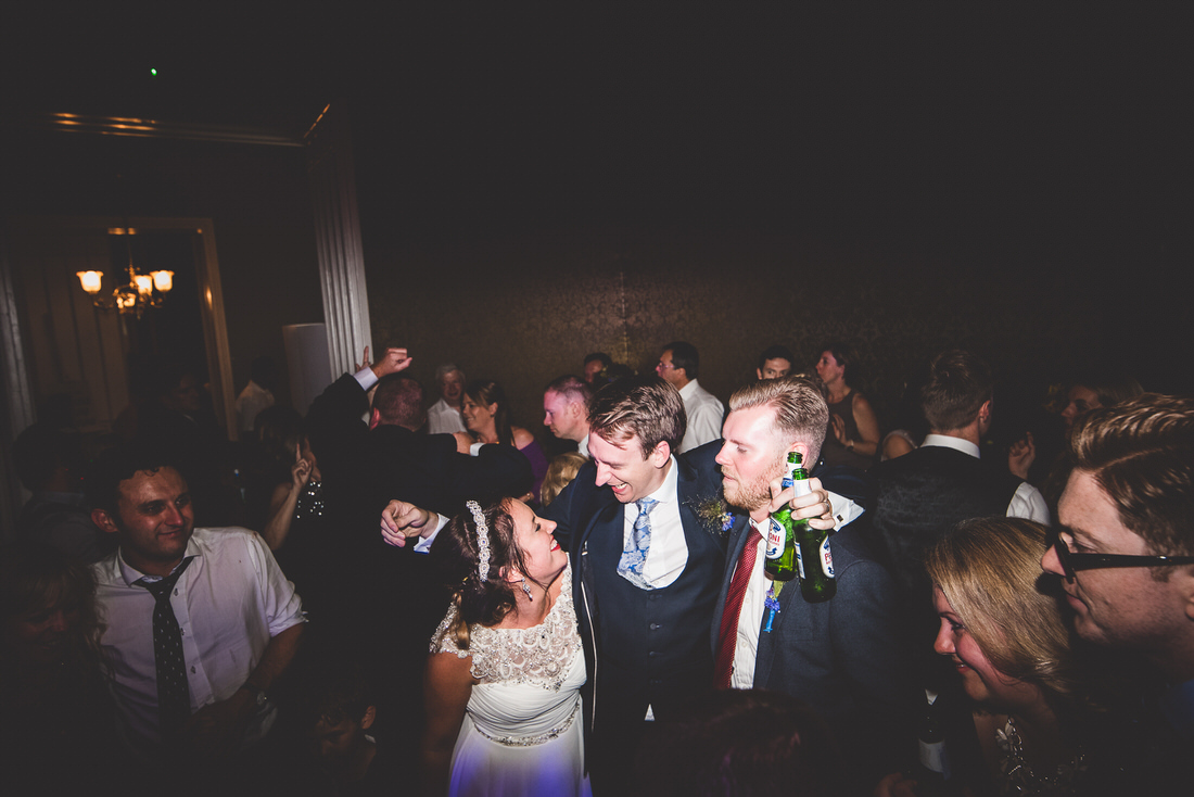 A bride and groom captured by a wedding photographer in a candid dance.