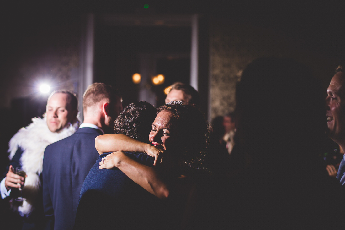 A groom embracing his bride in a wedding photo.