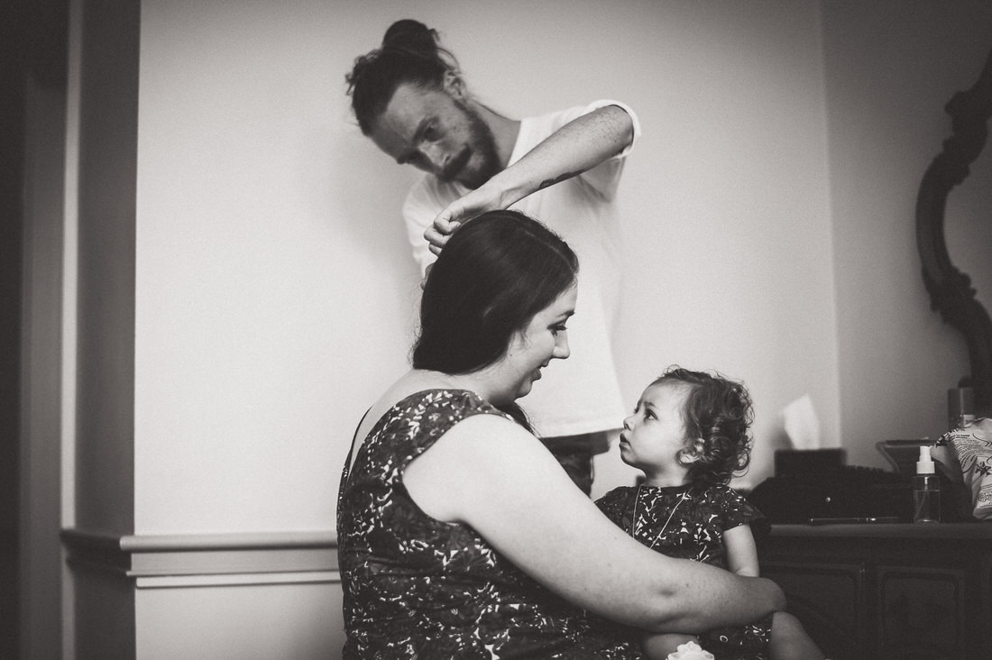 A woman is getting her daughter's hair done for the wedding.