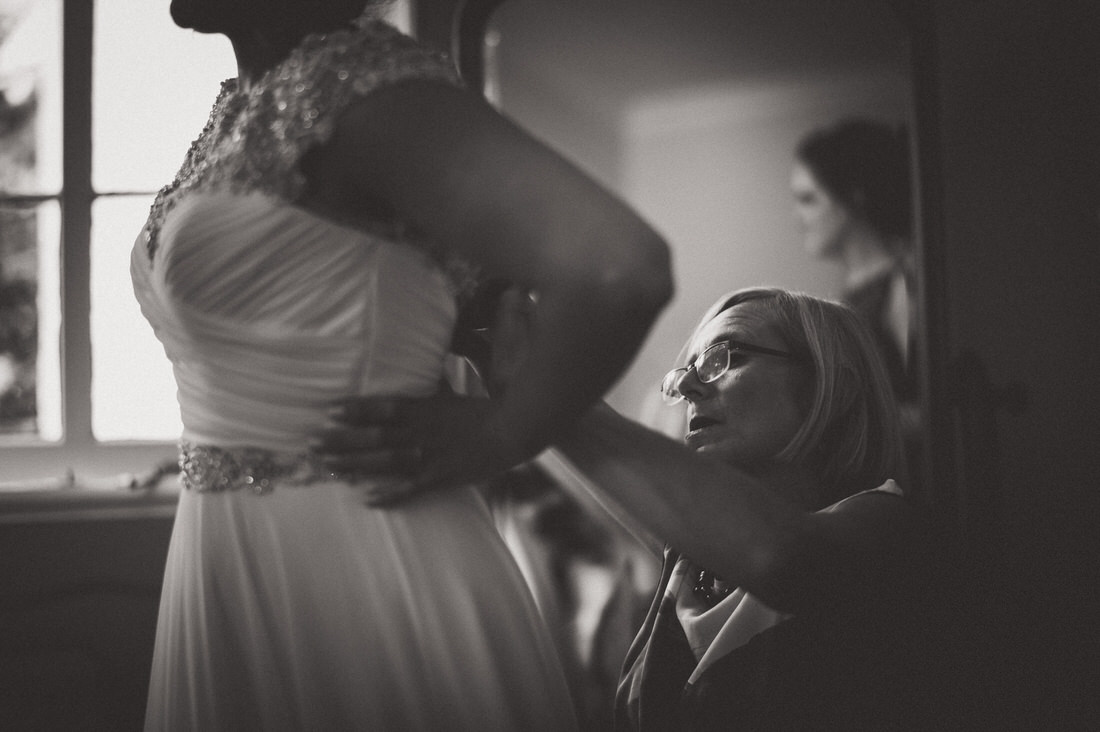 A bride preparing for her wedding day as she admires herself in front of a mirror.