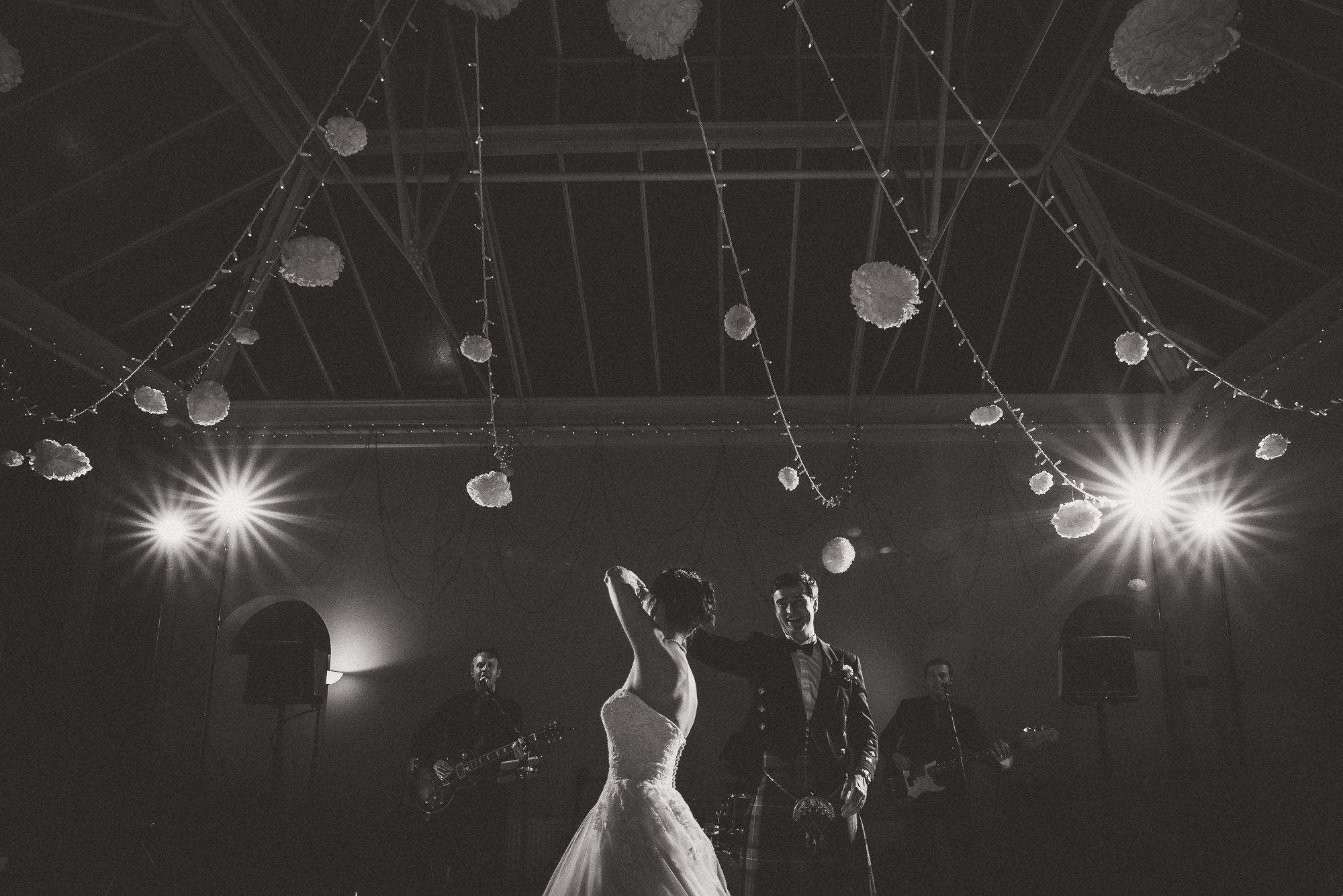 A groom and bride dancing together captured by a wedding photographer.