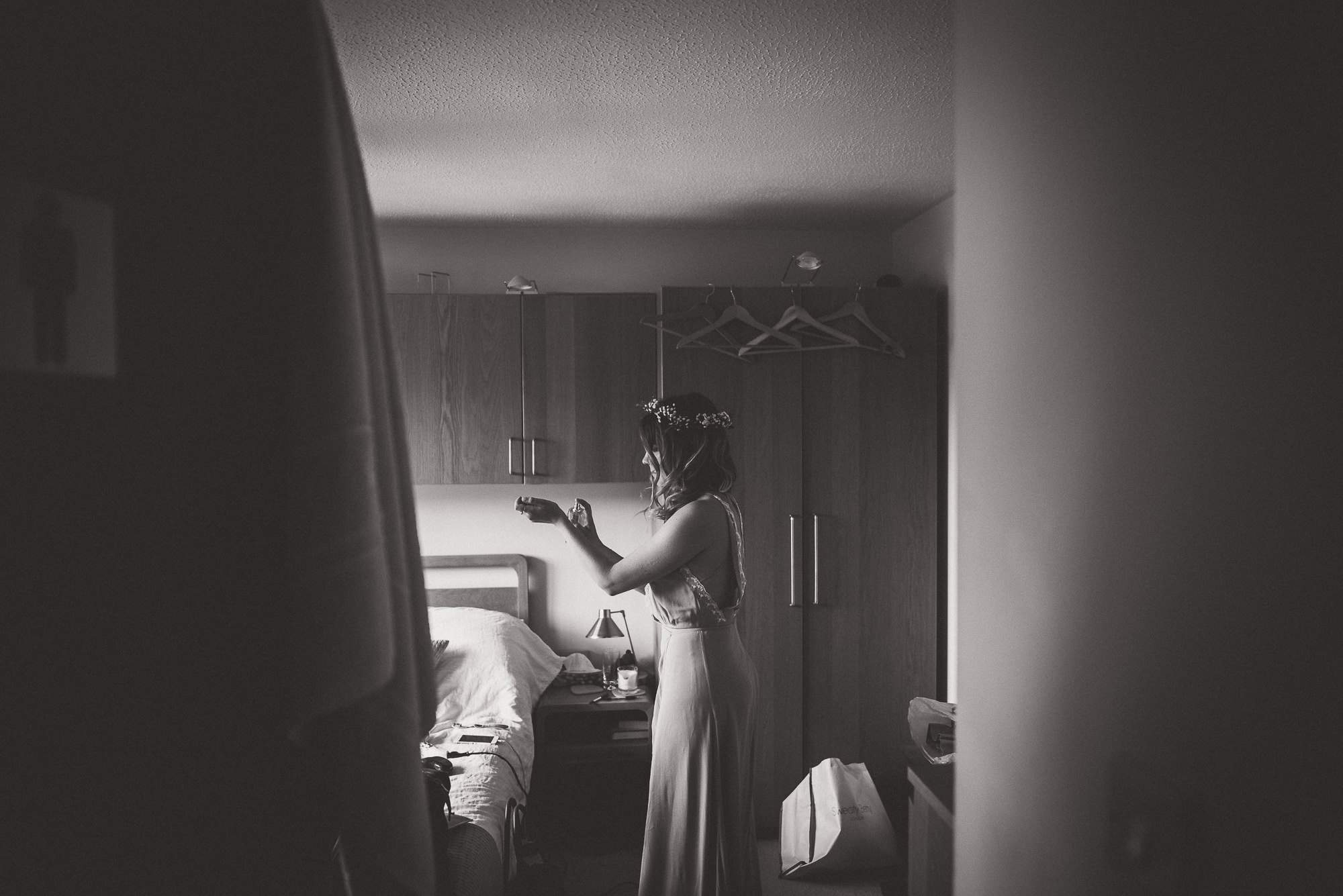 A bride in a wedding dress posing for a wedding photo in front of a mirror.