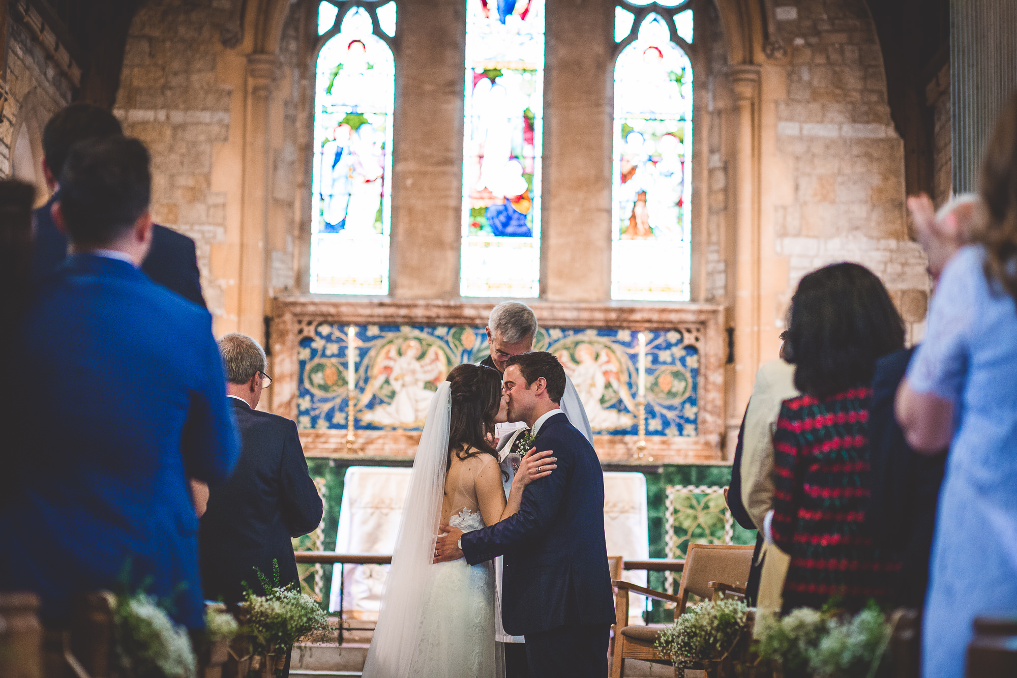 A wedding photo capturing a loving moment between the bride and groom in a church.