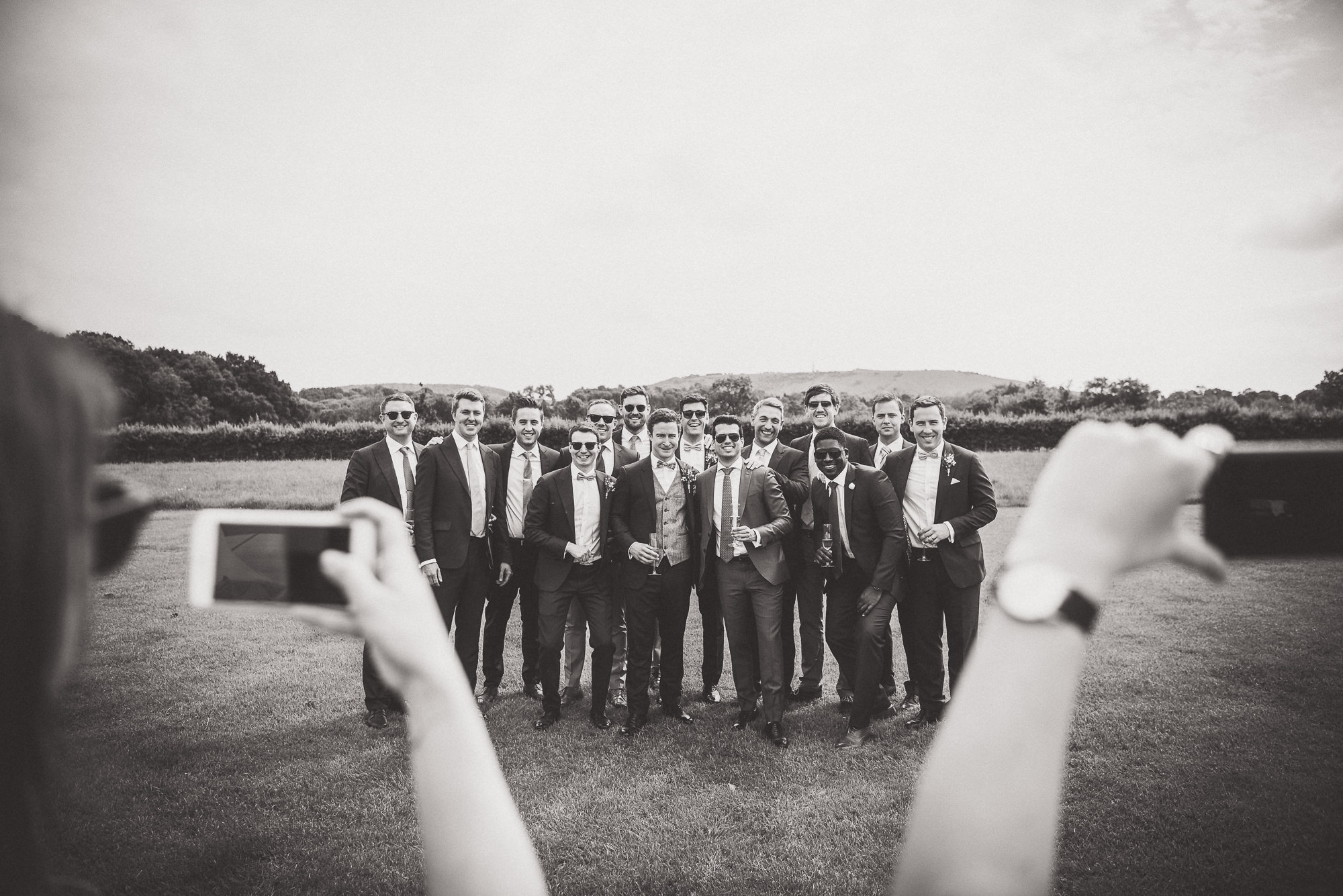 A group of groomsmen posing for the wedding photographer.