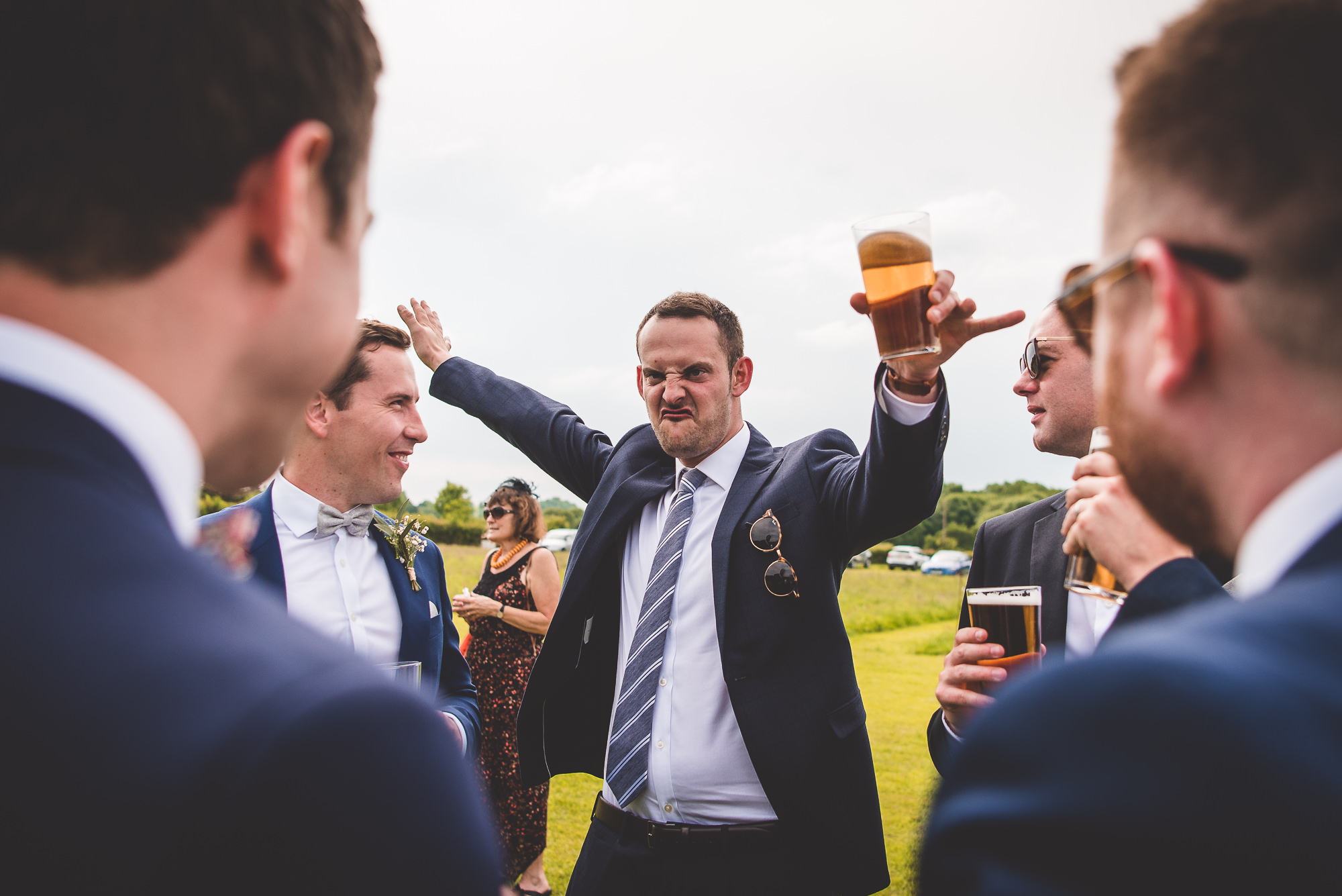 A bride and groom share a cheers in their wedding photo.