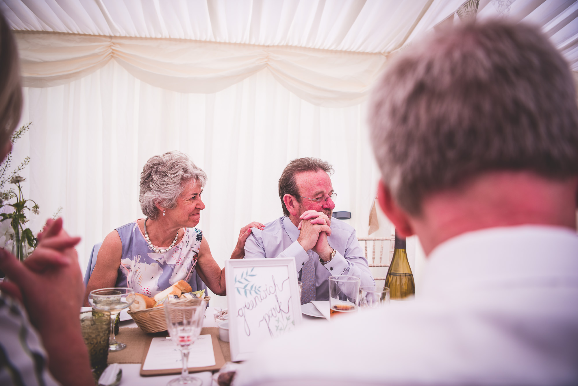 A group of people sitting at a wedding table.