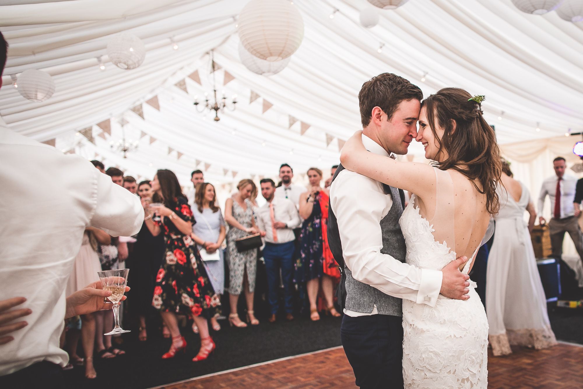 A wedding photo capturing the groom and bride sharing their first dance.