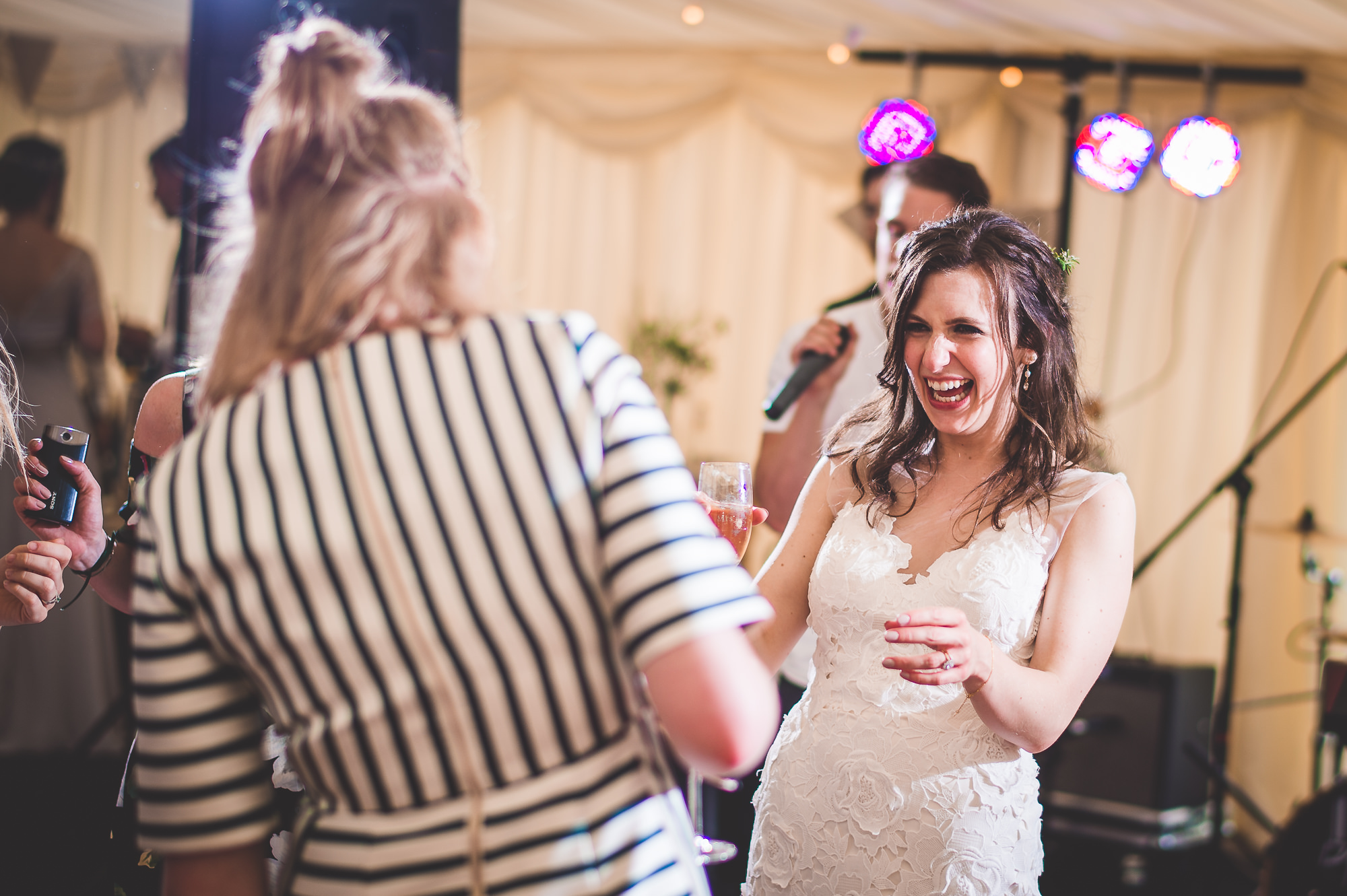 A wedding photo capturing the jovial bride and groom during their reception.