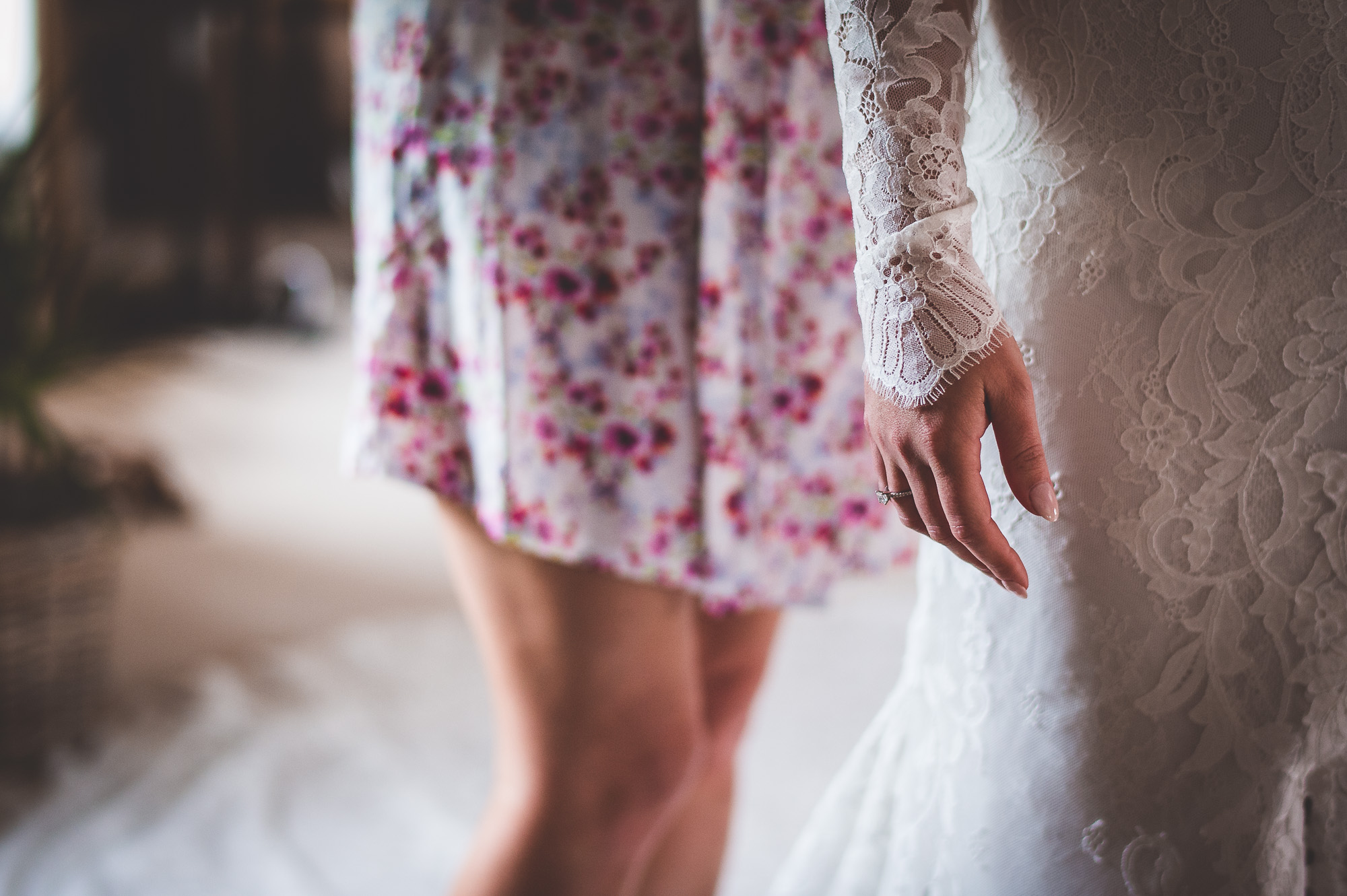 A bride is preparing for her wedding day by putting on her wedding dress.