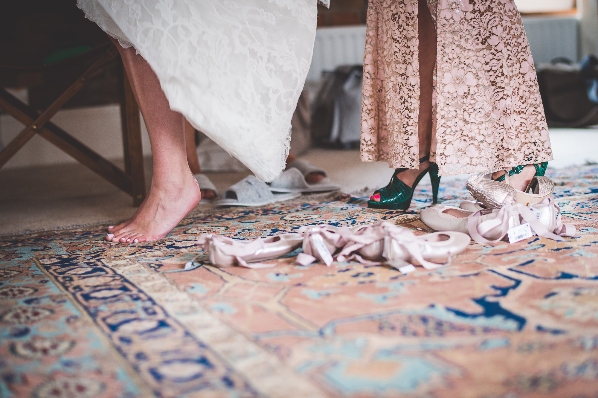 A bride and her bridesmaids posing for a wedding photo on a rug.