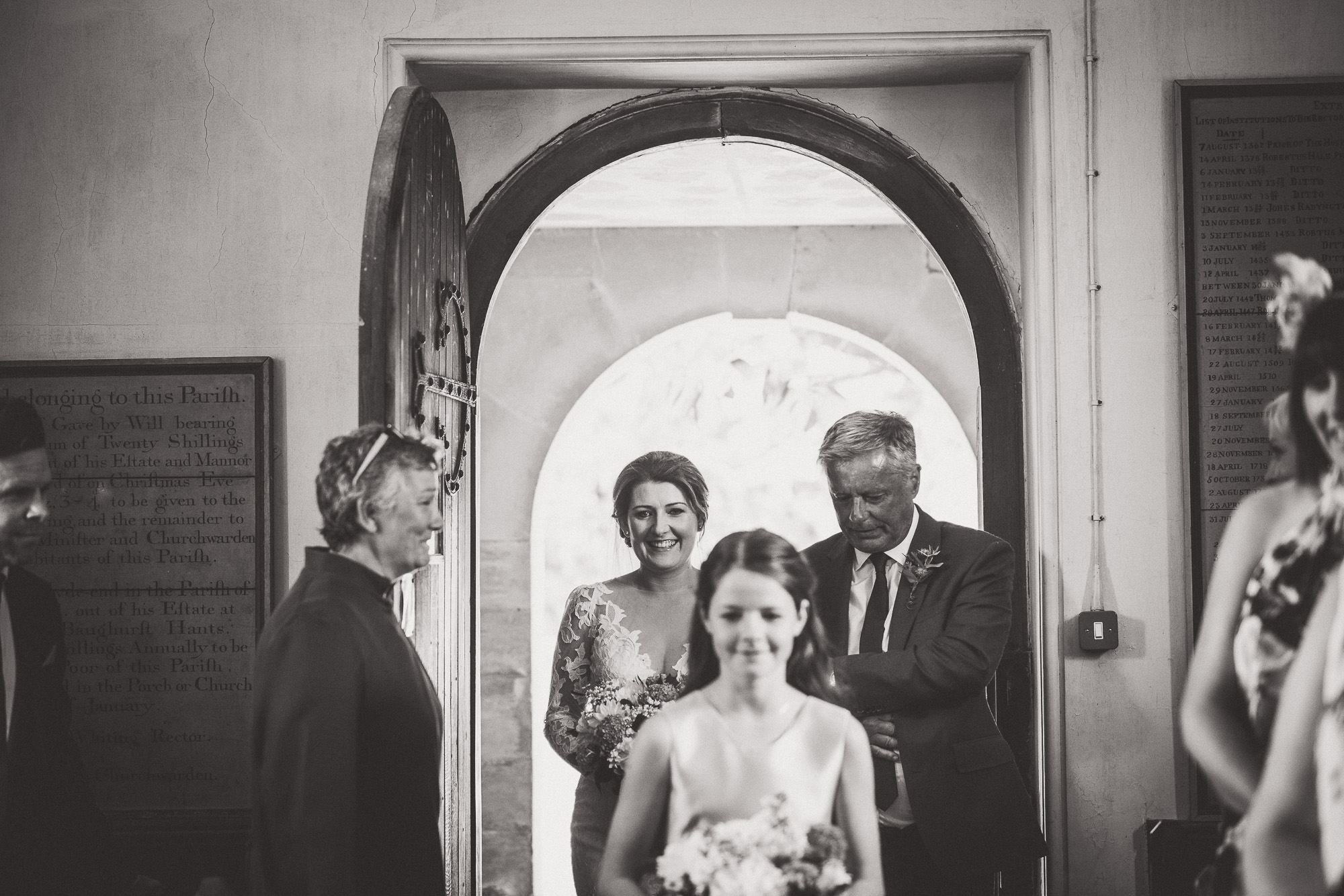 A bride is accompanied by her bridesmaids during her wedding.