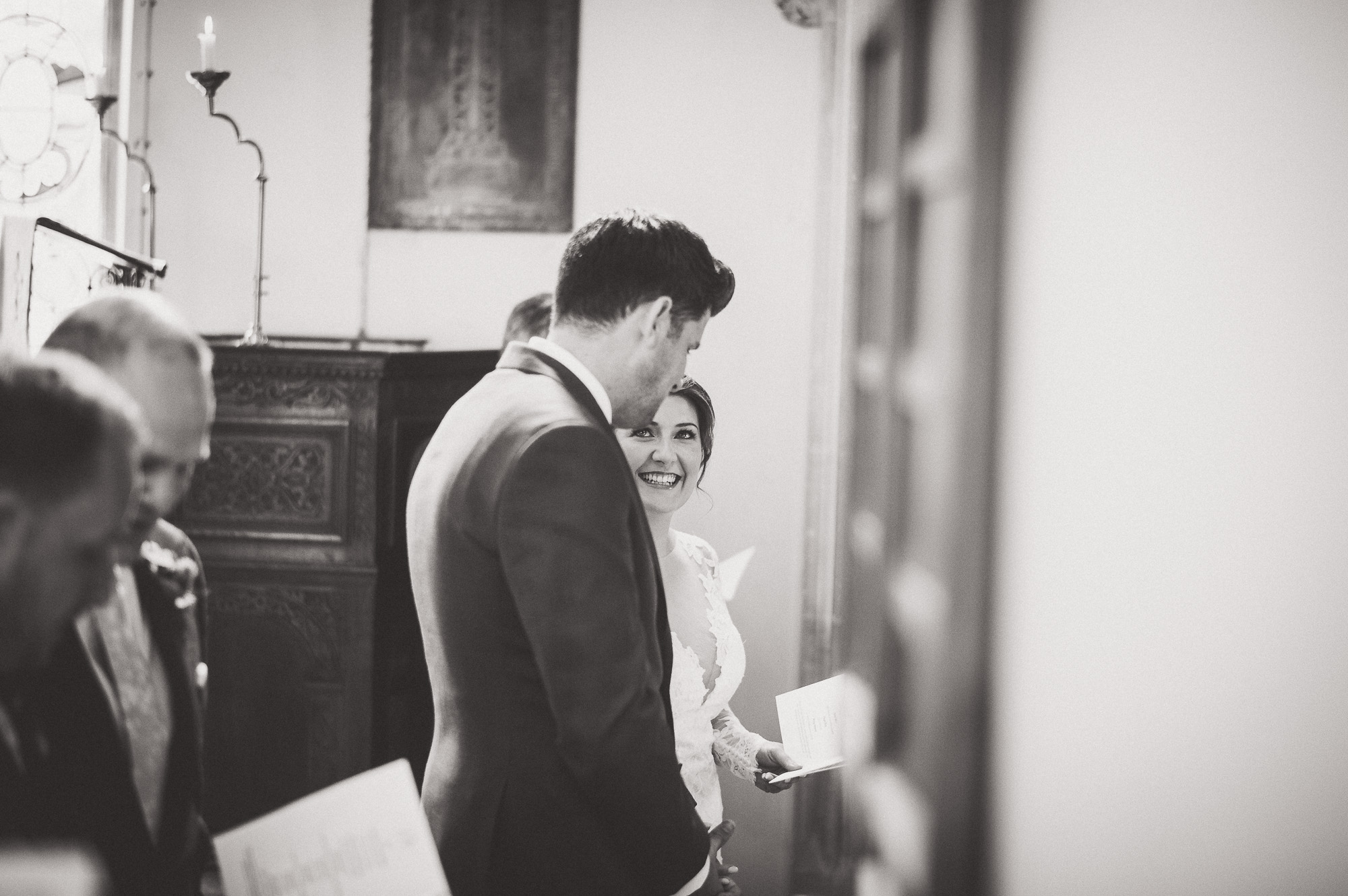A wedding photographer captures an intimate exchange between the bride and groom during their wedding ceremony.