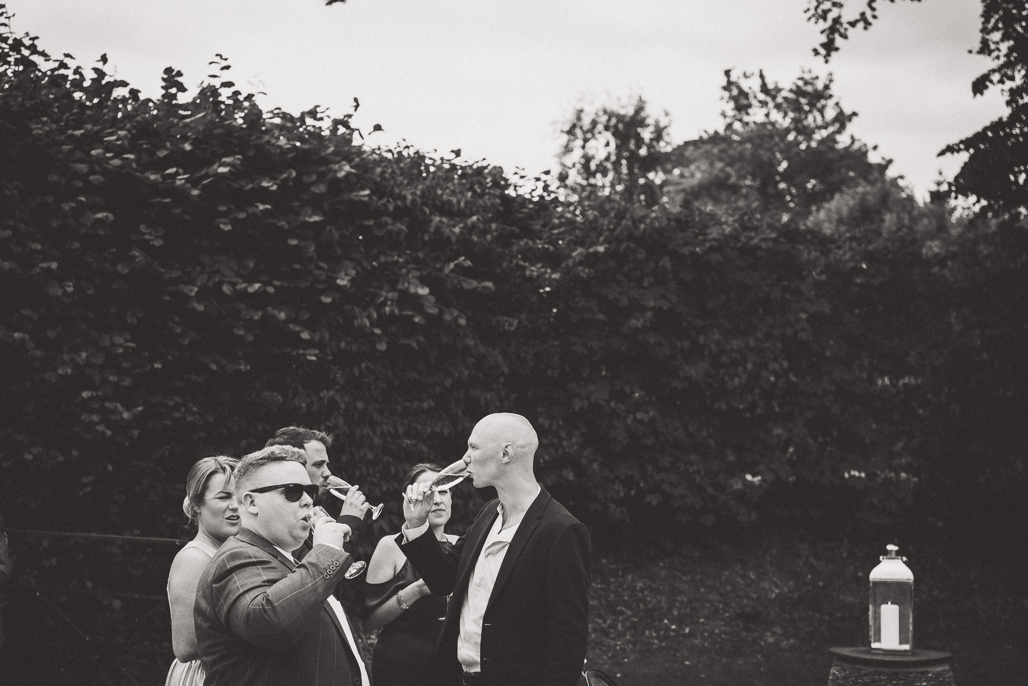 A black and white wedding photo capturing a group of people.