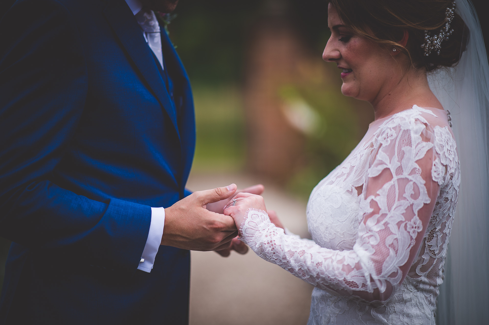 A bride and groom exchanging their wedding rings.