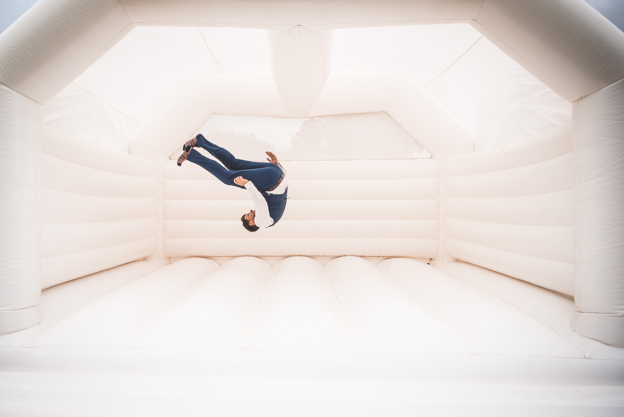 A man performing a flip at a wedding.