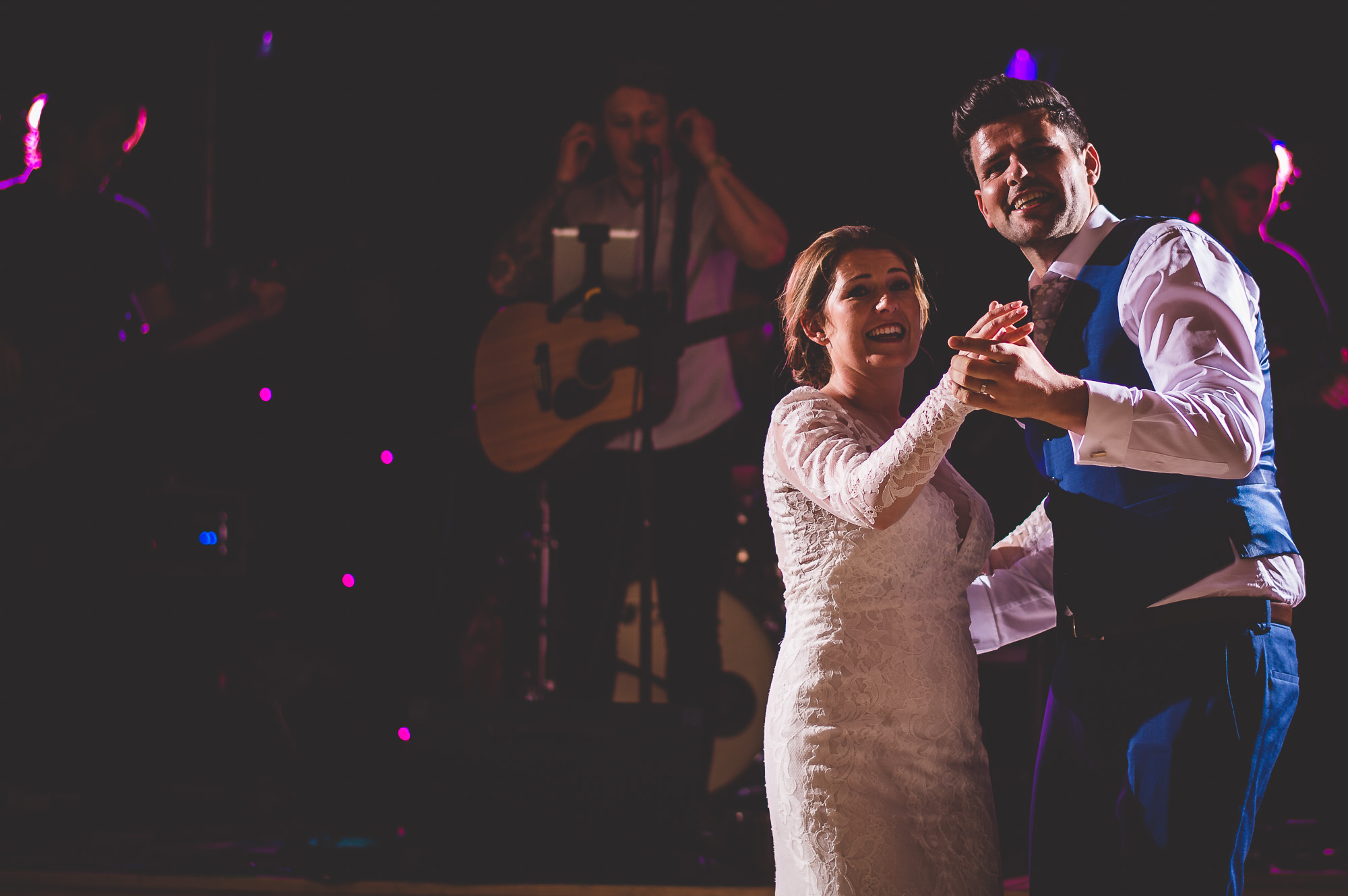 A bride and groom dancing at their wedding reception captured by a wedding photographer.