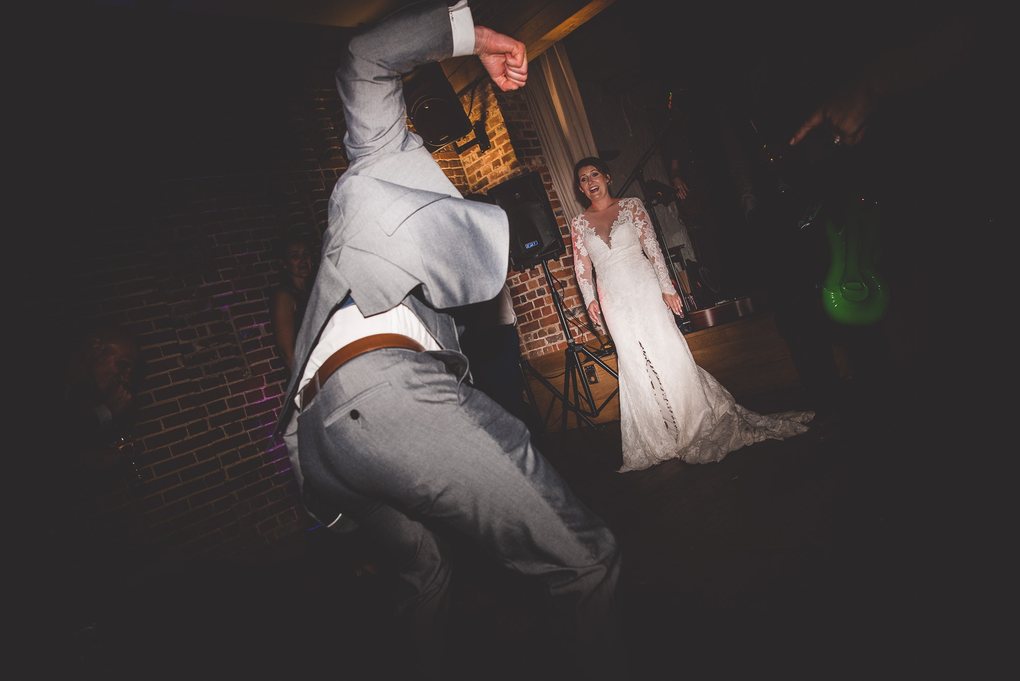 A bride and groom captured by a wedding photographer in a beautiful wedding photo at their reception.