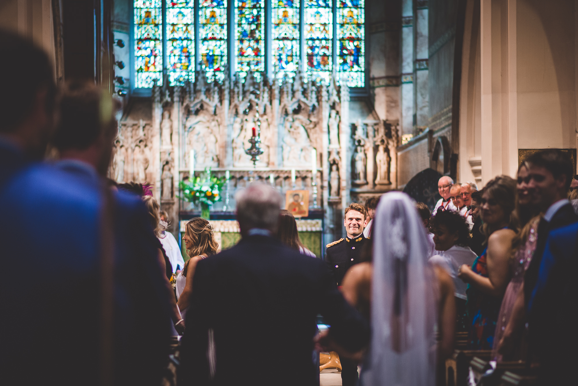 A bride and groom captured by a wedding photographer as they walk down the aisle during their special day.