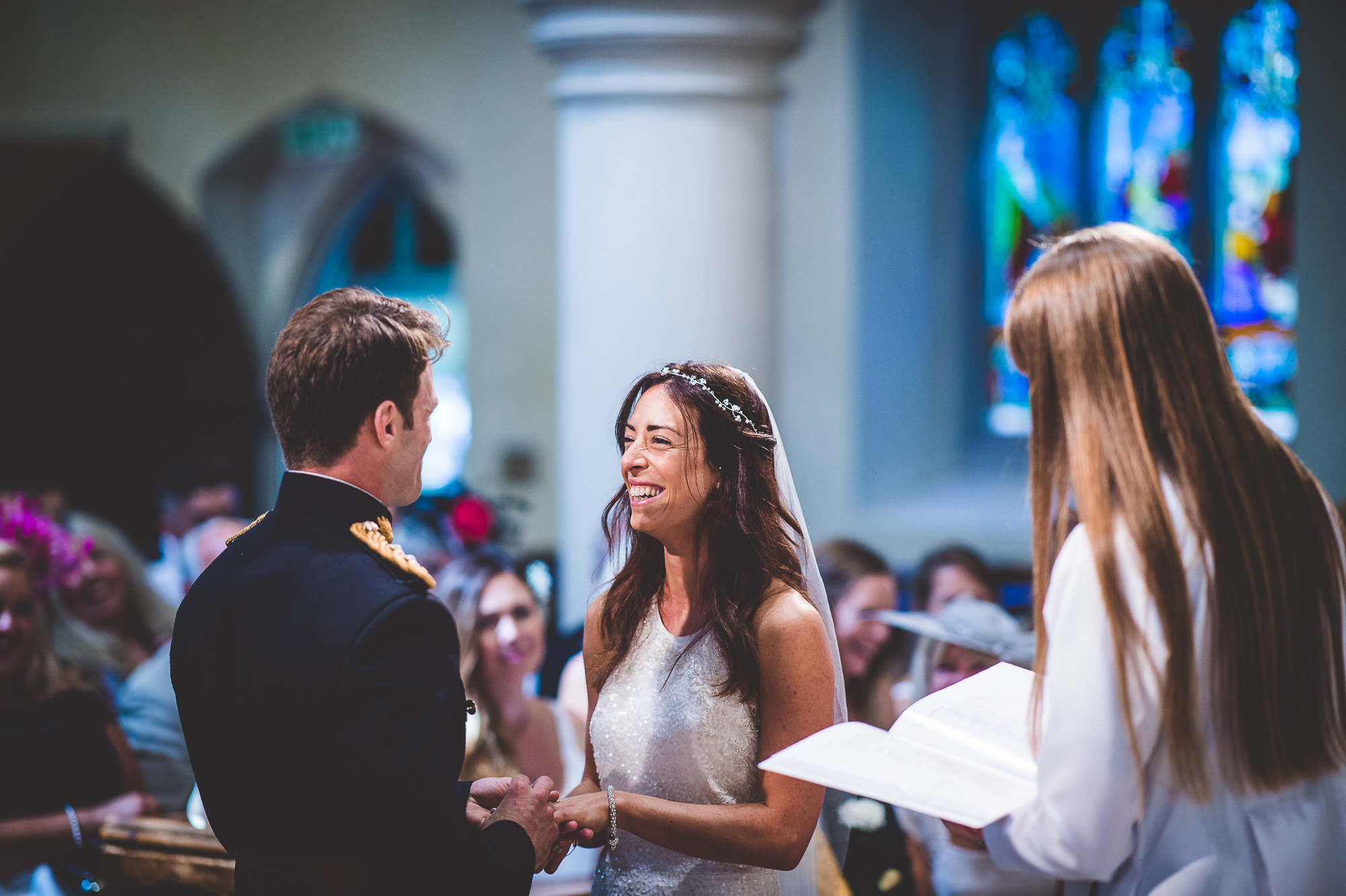 A wedding couple exchange vows in a church, captured by a wedding photographer.