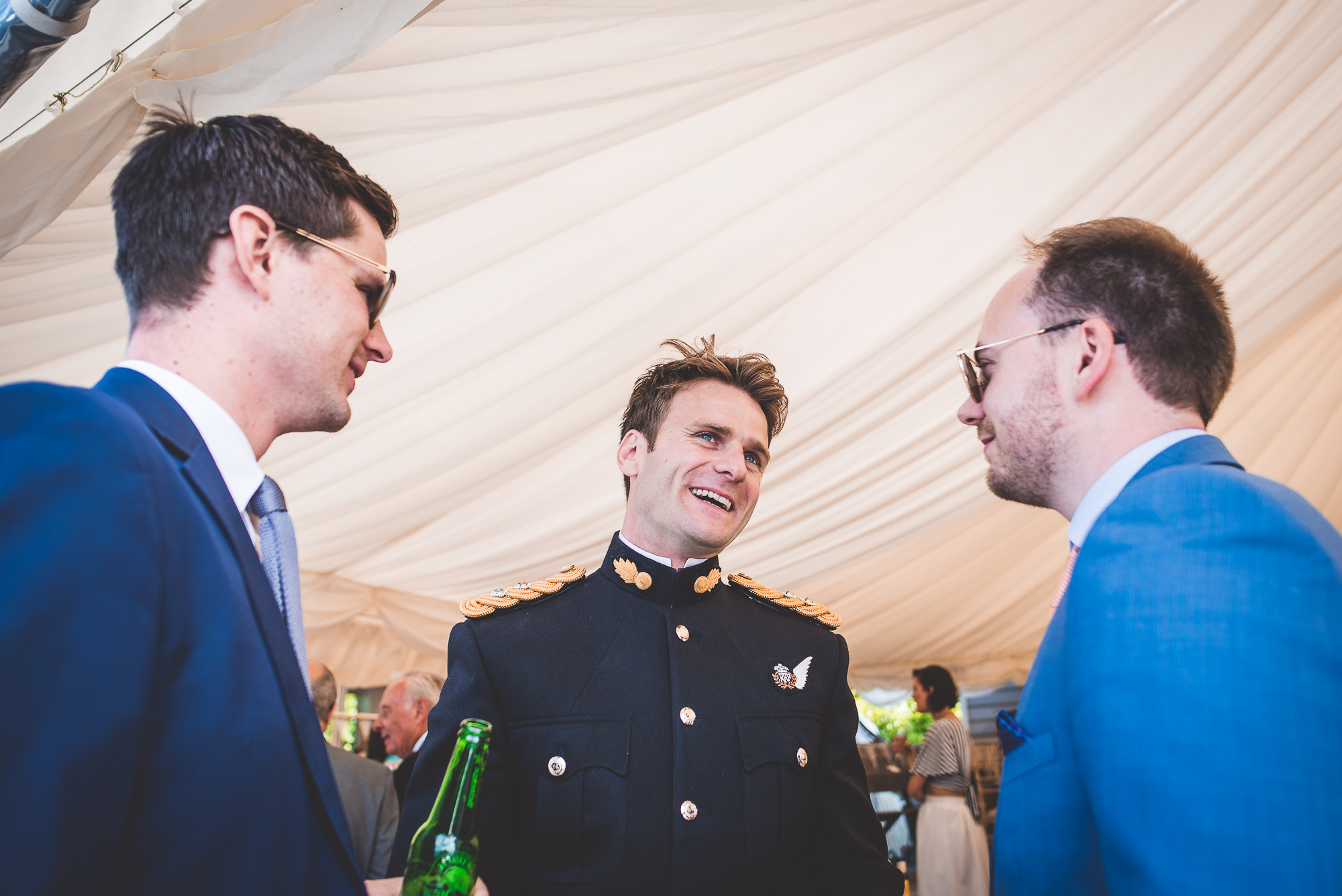 A groom in a blue suit at his wedding.