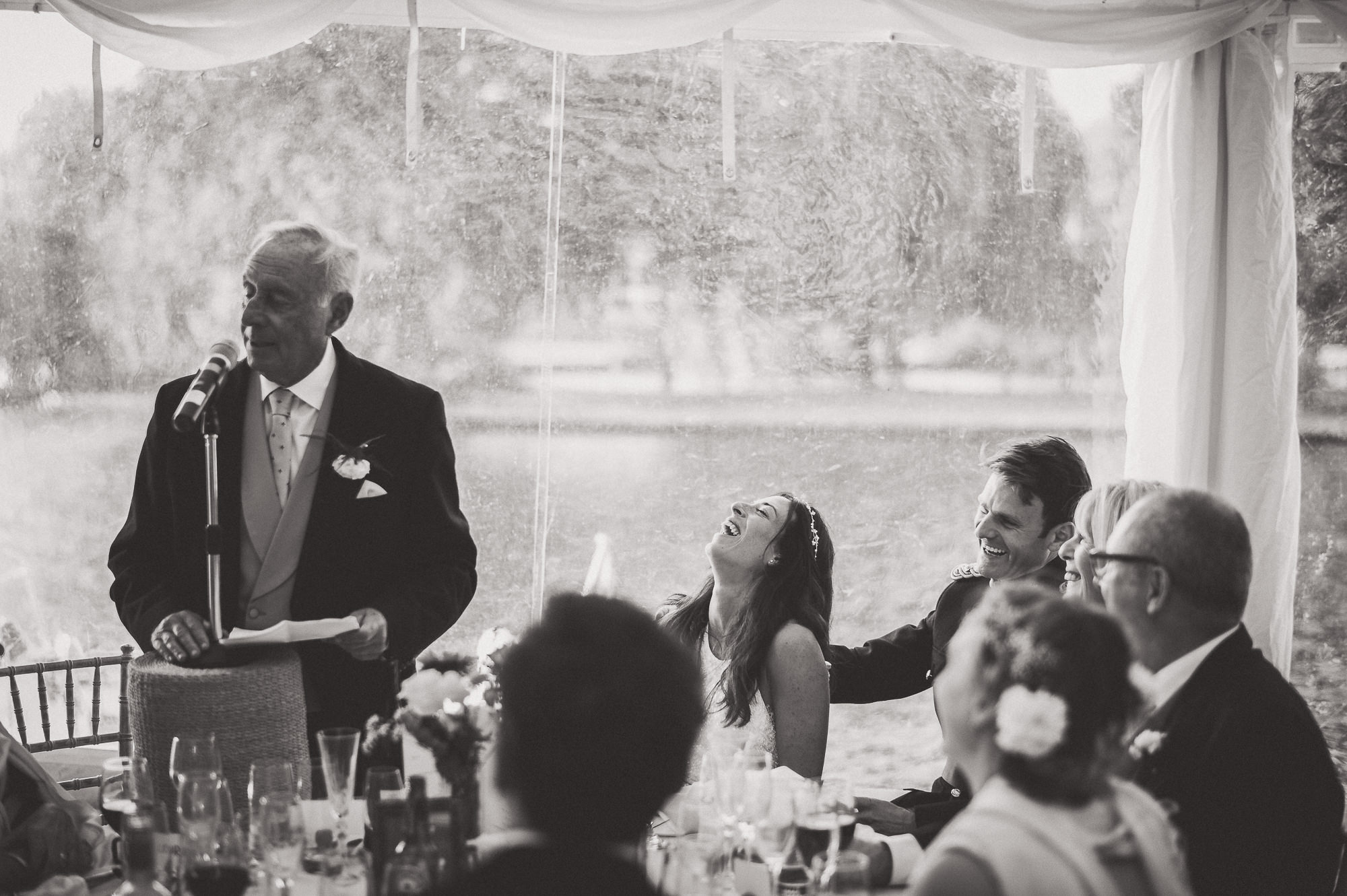 A groom giving a speech at a wedding.